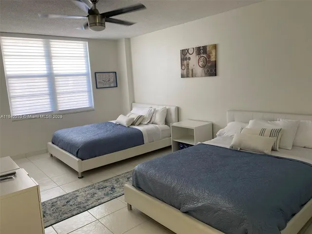 a bedroom with a bed and a potted plant