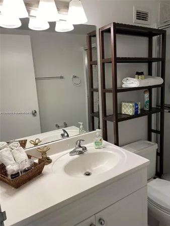 a bathroom with a sink vanity and mirror