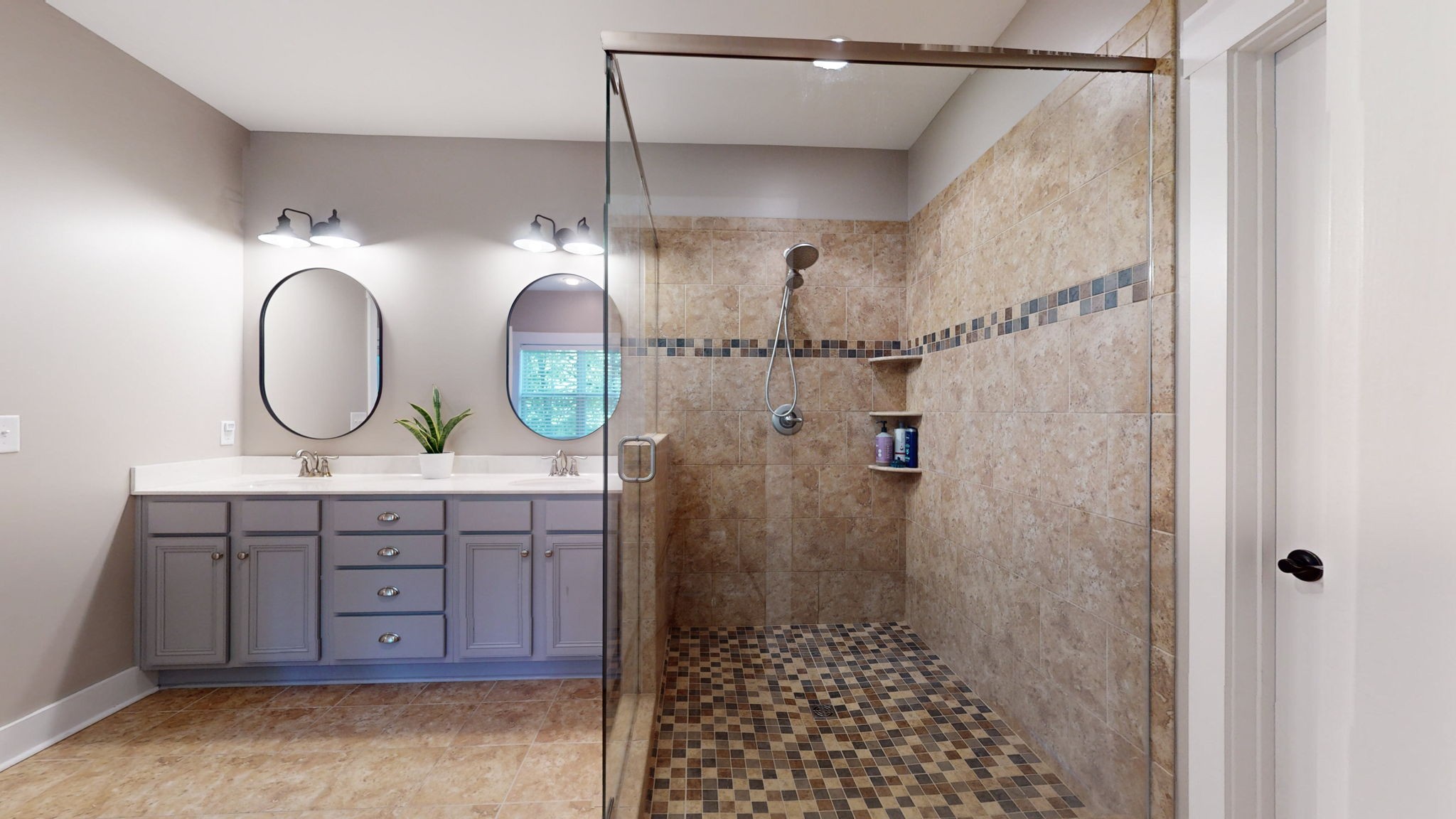 4852 Ash Hill Road Spring Hill, TN 37174 - Photo 20 of 60 a bathroom with a sink a mirror a vanity and a shower