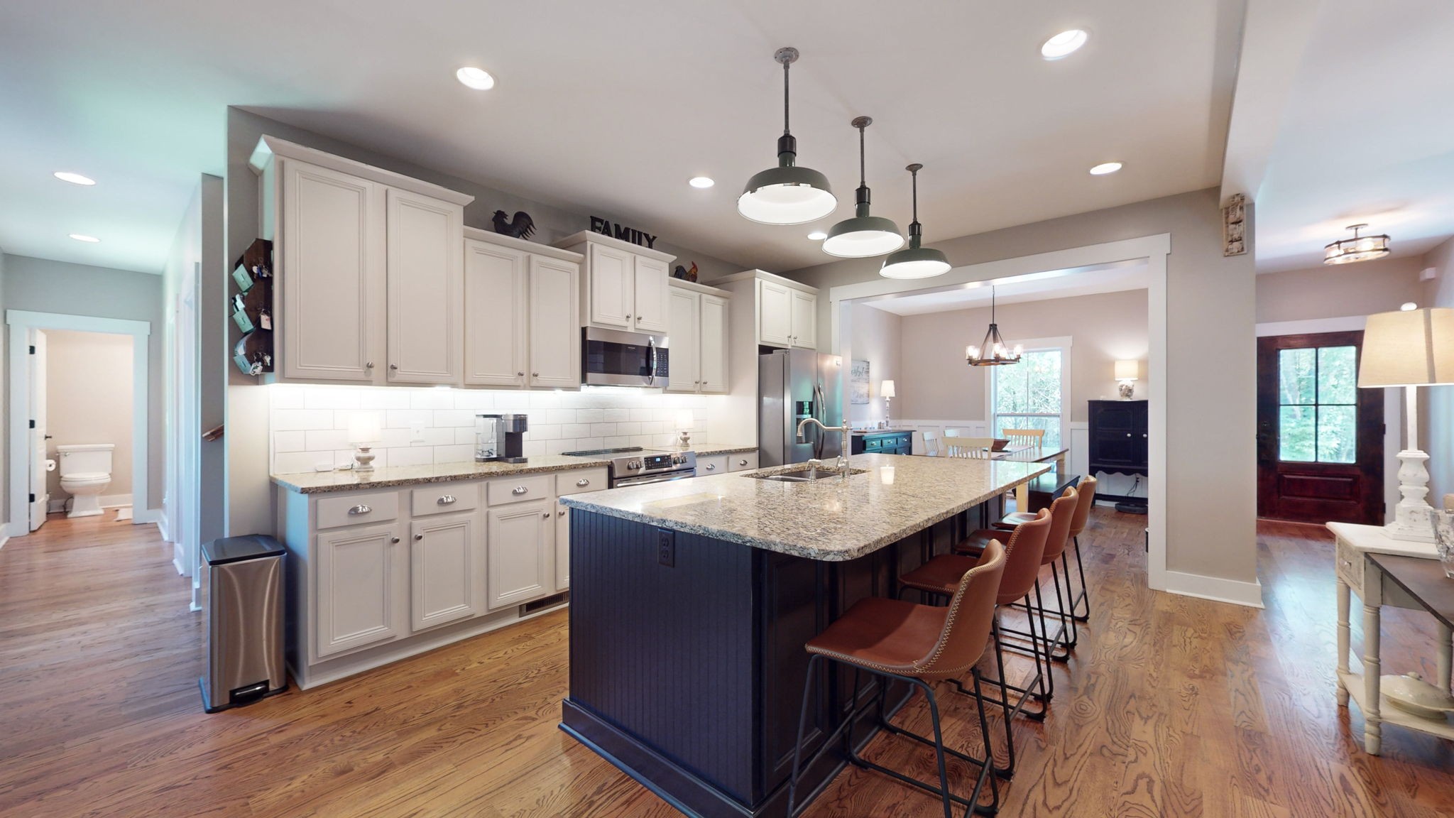 4852 Ash Hill Road Spring Hill, TN 37174 - Photo 25 of 60 a kitchen with stainless steel appliances kitchen island granite countertop a table chairs and a sink
