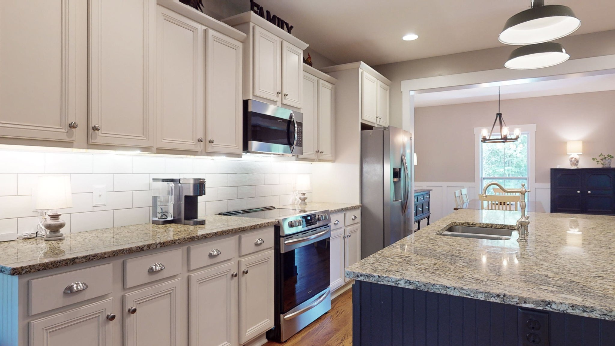 4852 Ash Hill Road Spring Hill, TN 37174 - Photo 26 of 60 a kitchen with granite countertop a sink a stove and refrigerator