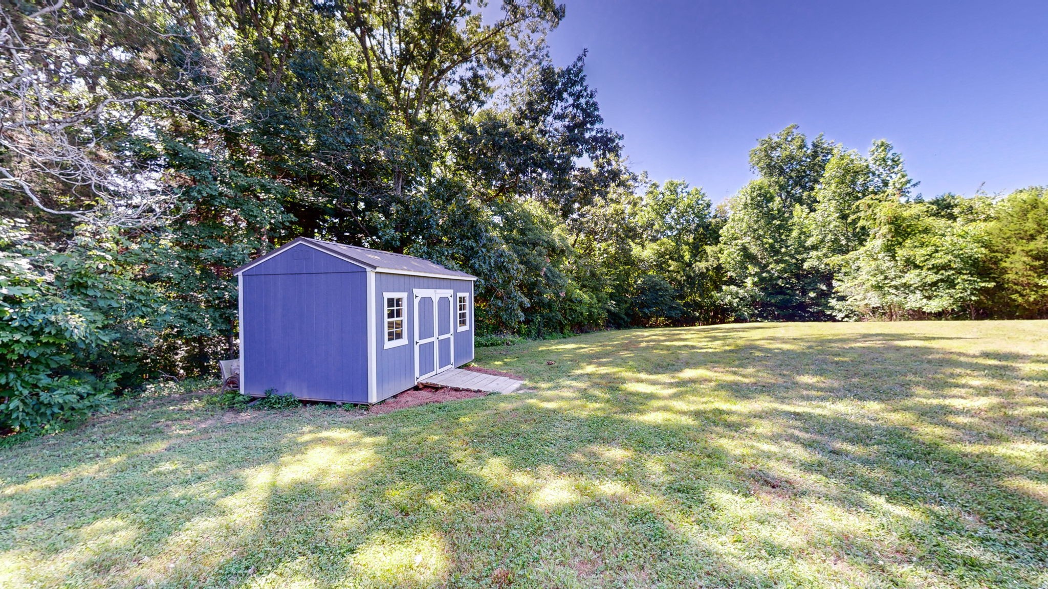 4852 Ash Hill Road Spring Hill, TN 37174 - Photo 58 of 60 a view of a backyard with potted plants and large trees