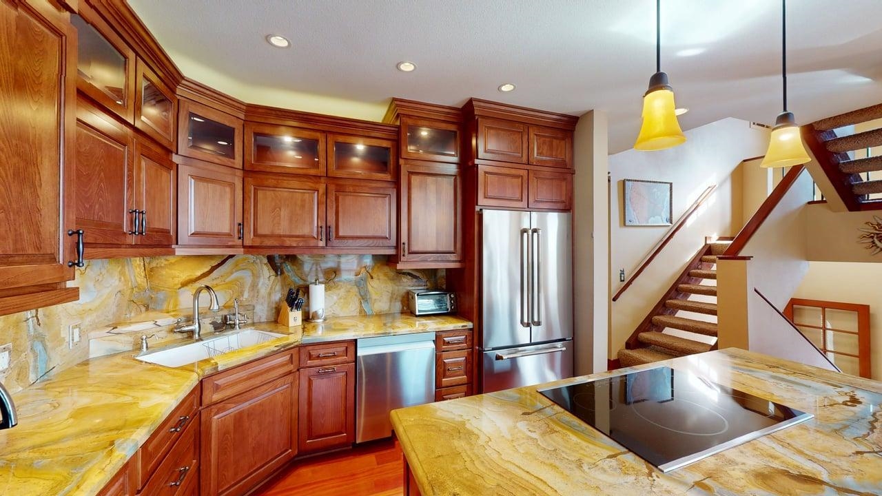 3600 Chateau Road, Unit 2 Mammoth Lakes, CA 93546 - Photo 3 of 30 Kitchen featuring stainless steel appliances, backsplash, hanging light fixtures, glass insert cabinets, and wooden counters