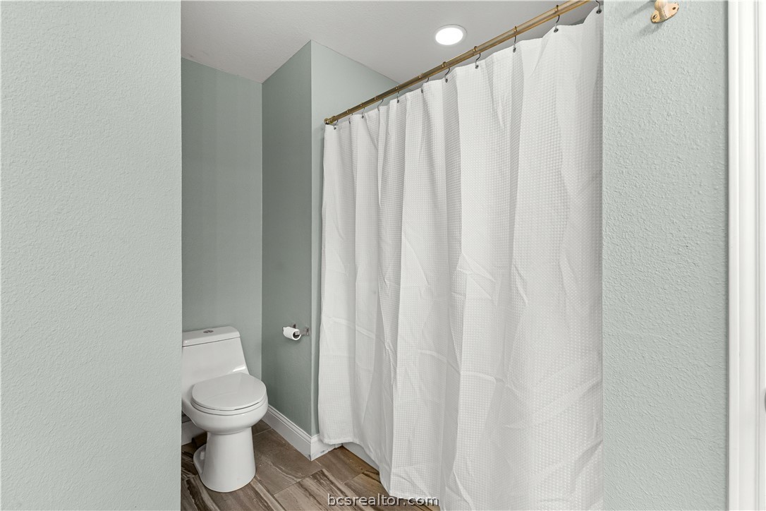 3709 Springfield Drive College Station, TX 77845 - Photo 13 of 23 a white toilet sitting next to a small window