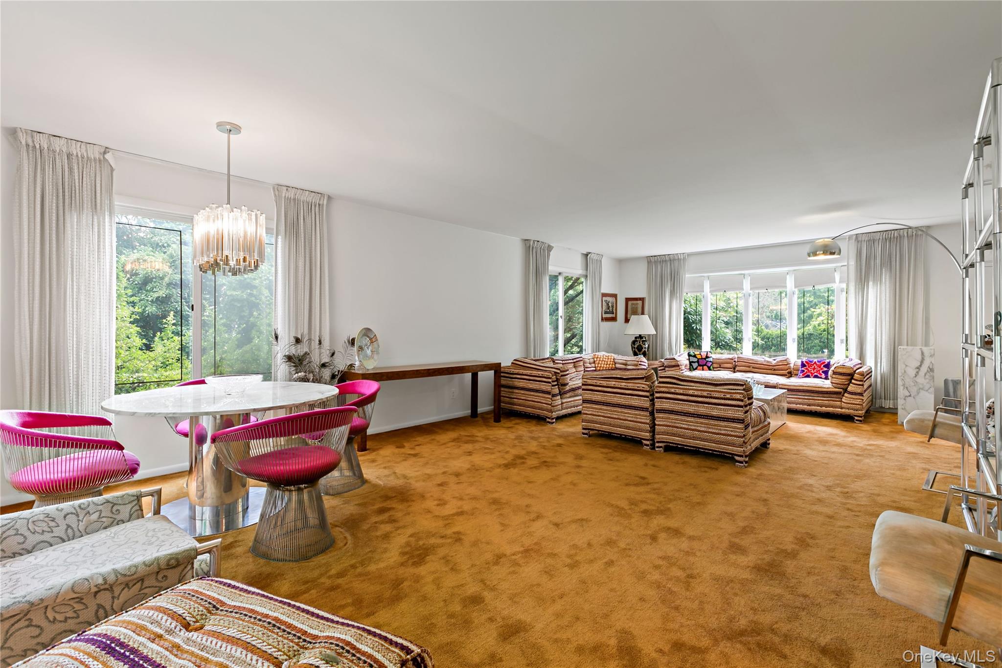 16 Meadow Road Scarsdale, NY 10583 - Photo 7 of 47 a bedroom with furniture and a chandelier