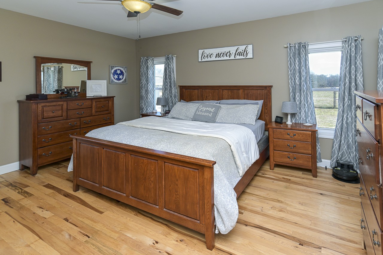 182 Old Camargo Road Fayetteville, TN 37334 - Photo 12 of 59 a bedroom with a bed and a chandelier