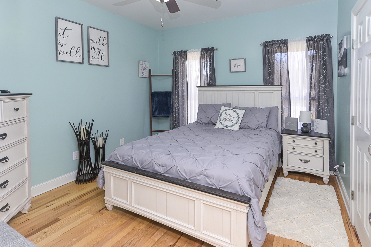 182 Old Camargo Road Fayetteville, TN 37334 - Photo 19 of 59 a bedroom with a large bed and a wooden floor