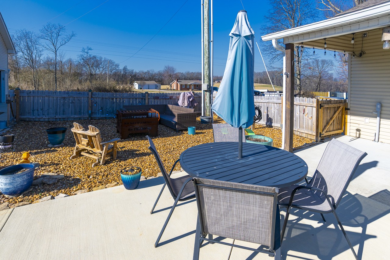 182 Old Camargo Road Fayetteville, TN 37334 - Photo 31 of 59 a view of deck with table and chairs a barbeque and potted plants
