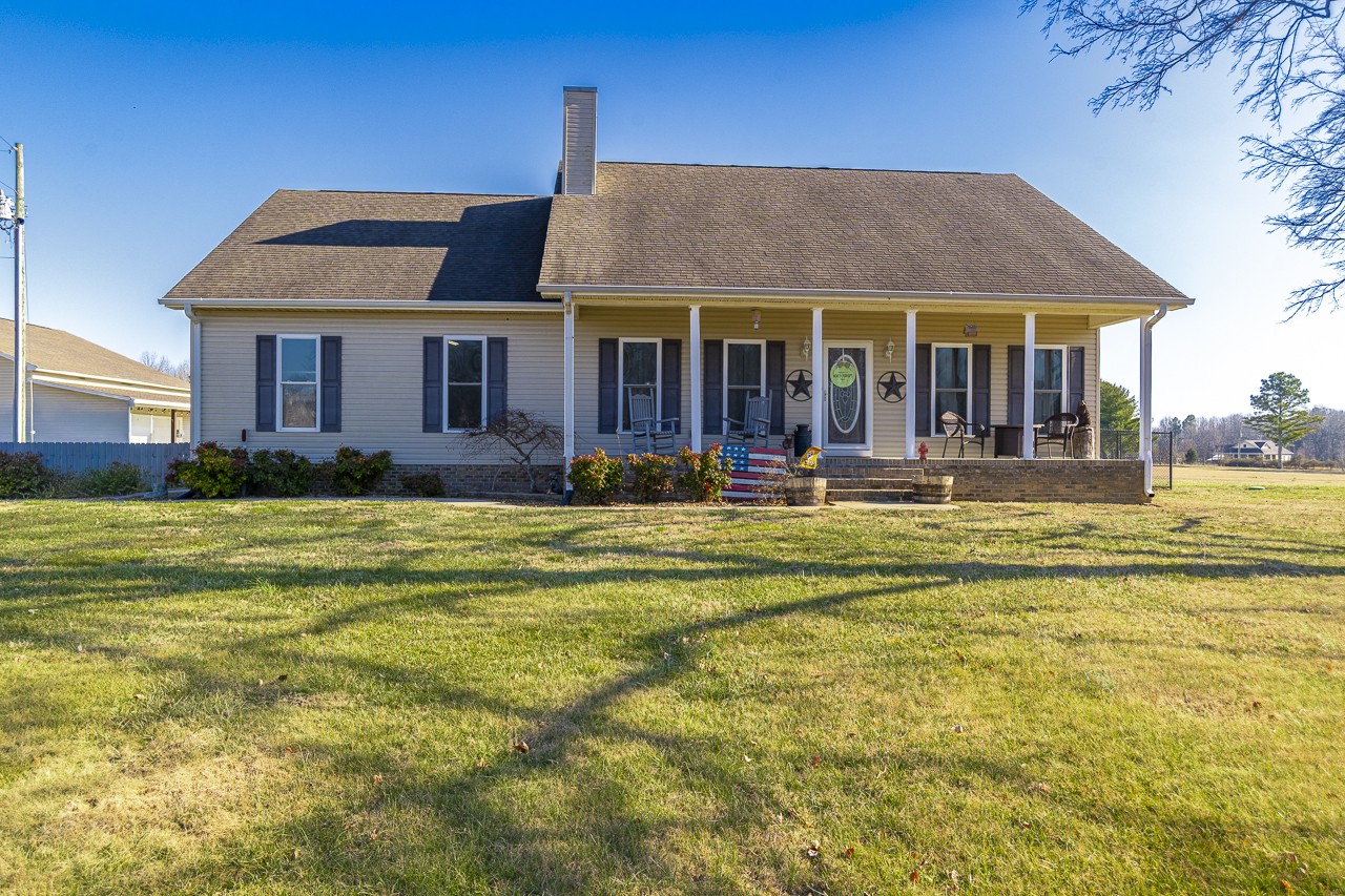 182 Old Camargo Road Fayetteville, TN 37334 - Photo 57 of 59 a view of a white house with a swimming pool table and chairs under an umbrella