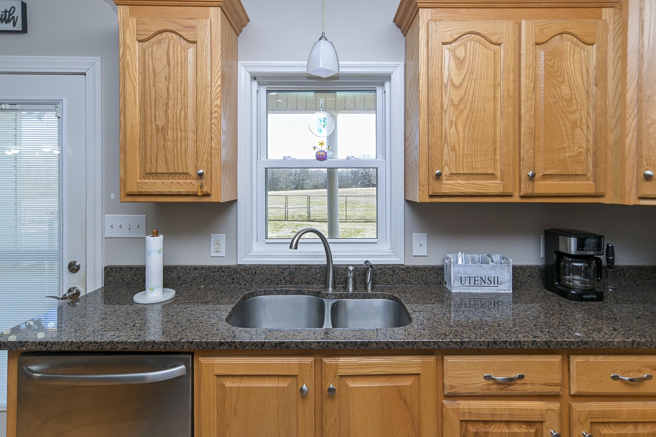 182 Old Camargo Road Fayetteville, TN 37334 - Photo 9 of 59 a kitchen with granite countertop stainless steel appliances a sink a window and cabinets