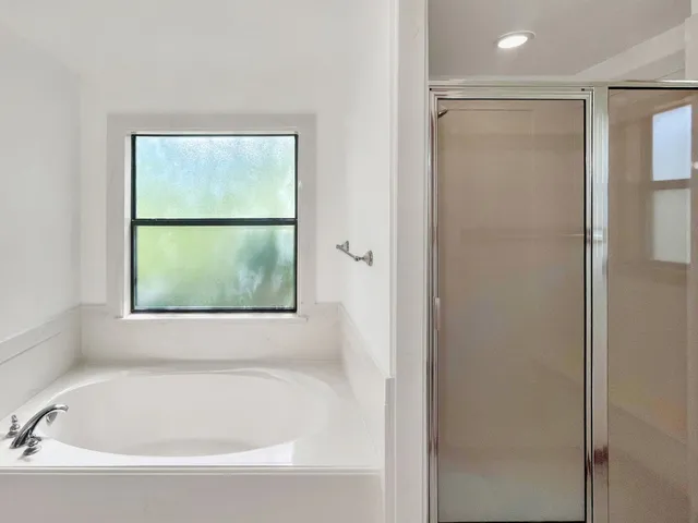 a white bath tub sitting next to a window
