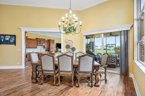 a view of a dining room with furniture wooden floor and chandelier