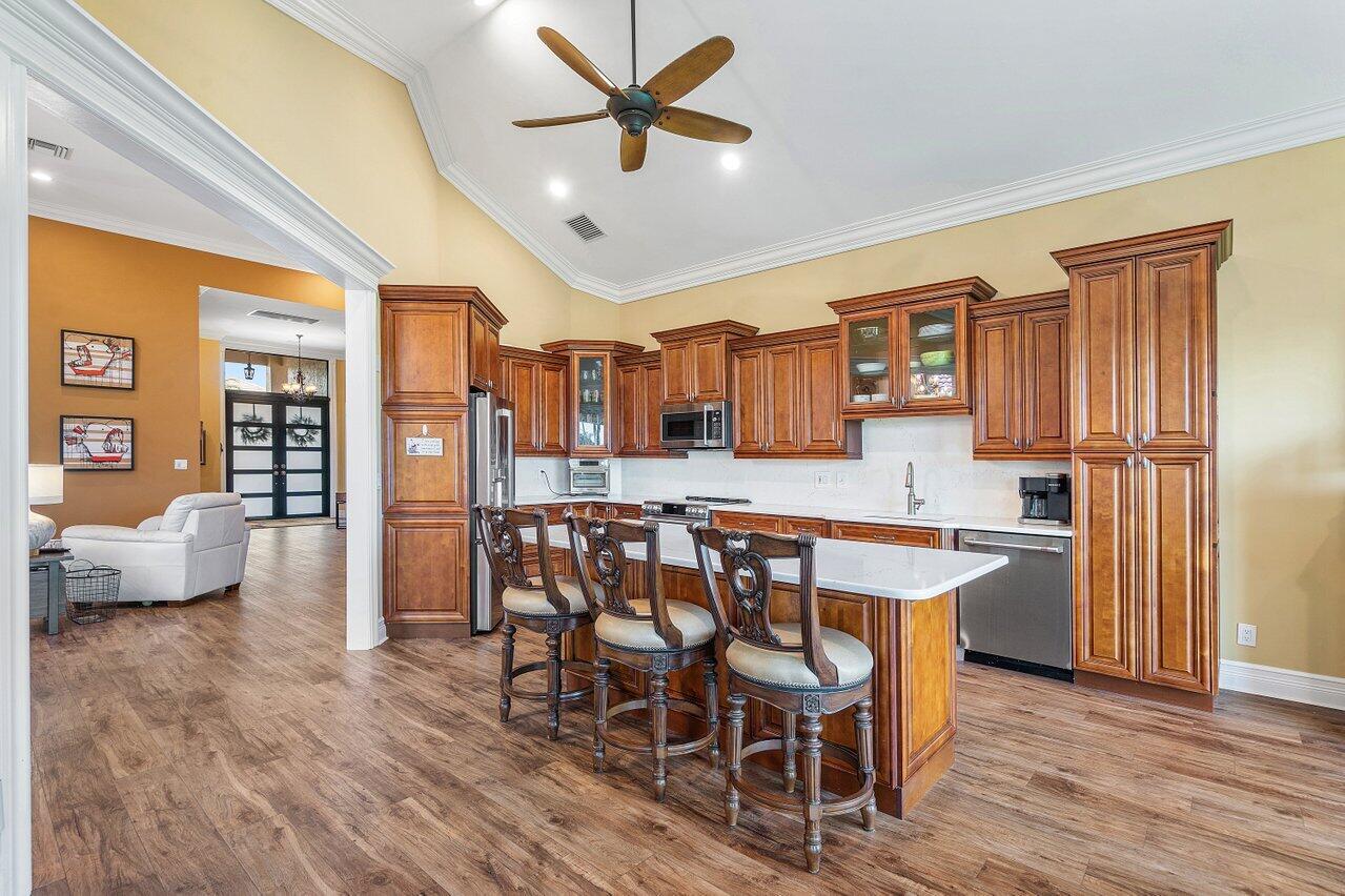 6052 Terra Mere Circle Boynton Beach, FL 33437 - Photo 13 of 52 a view of a dining room with furniture and wooden floor