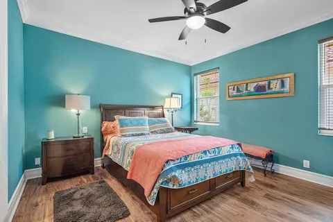 a bedroom with a bed and a chandelier