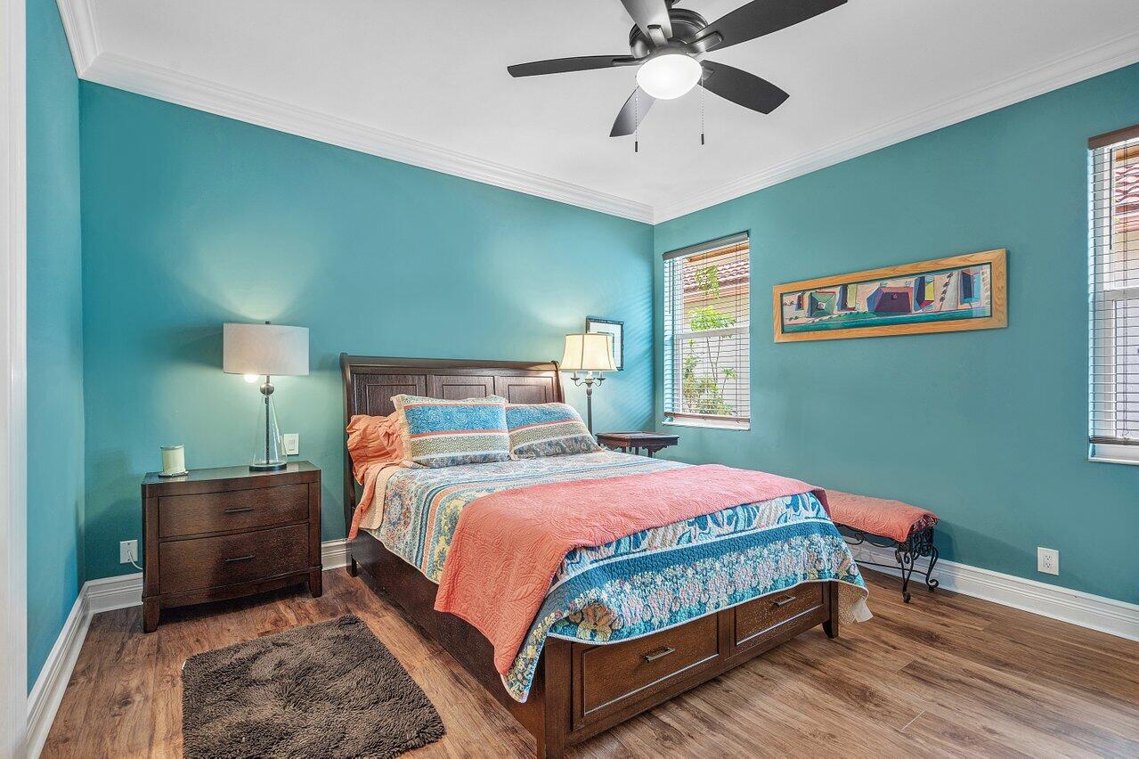 6052 Terra Mere Circle Boynton Beach, FL 33437 - Photo 27 of 52 a bedroom with a bed and a chandelier