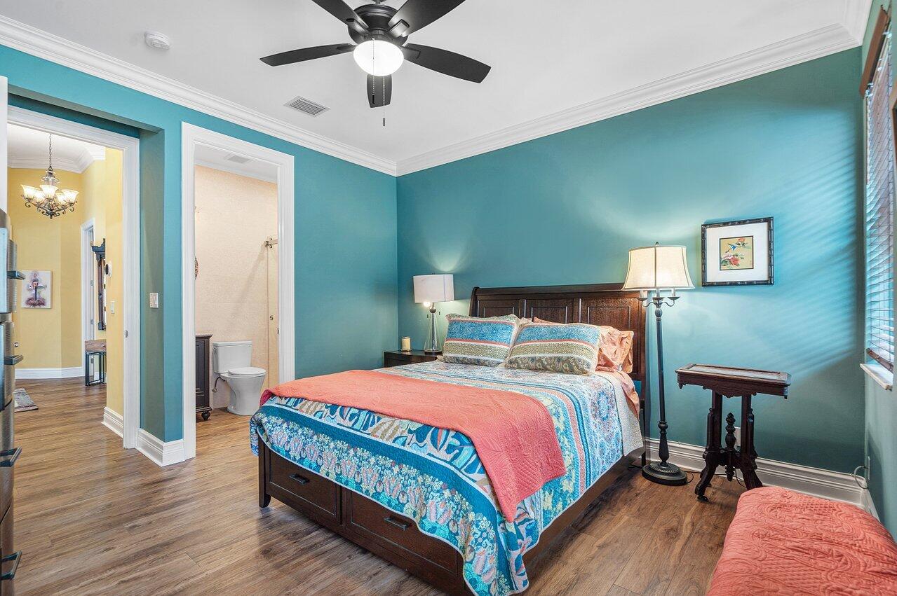 6052 Terra Mere Circle Boynton Beach, FL 33437 - Photo 28 of 52 a bedroom with a bed and a chandelier