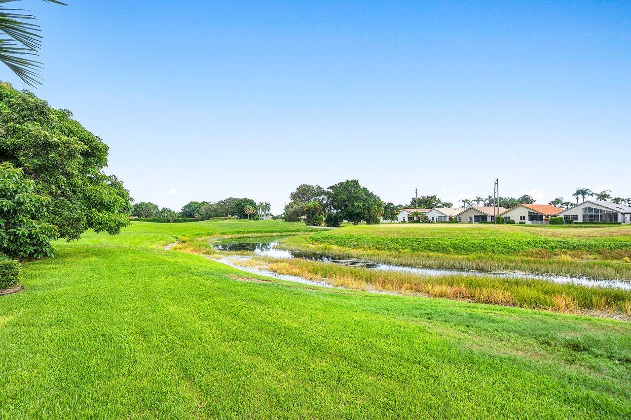 6052 Terra Mere Circle Boynton Beach, FL 33437 - Photo 37 of 52 a view of field with grass and trees in the background