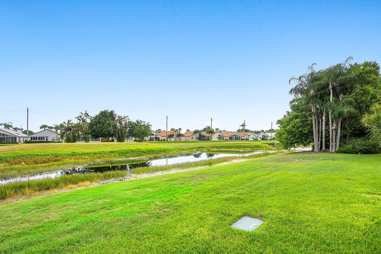 6052 Terra Mere Circle Boynton Beach, FL 33437 - Photo 38 of 52 a view of a golf course with a lake