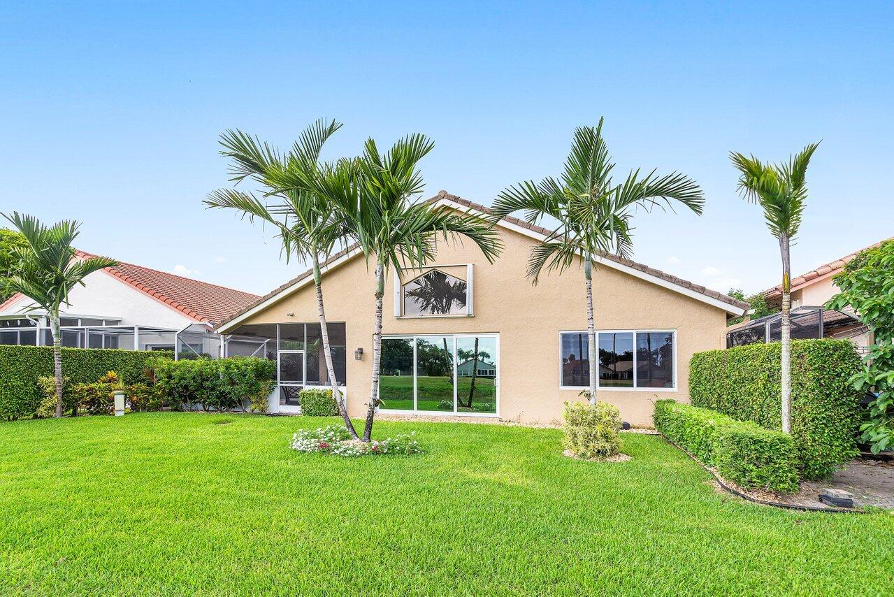 6052 Terra Mere Circle Boynton Beach, FL 33437 - Photo 41 of 52 a front view of a house with garden and porch