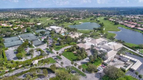 an aerial view of residential house with outdoor space and swimming pool