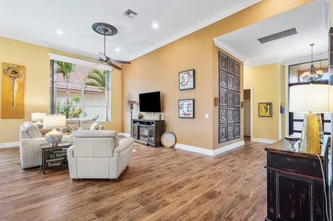a living room with furniture a flat screen tv and a dining table