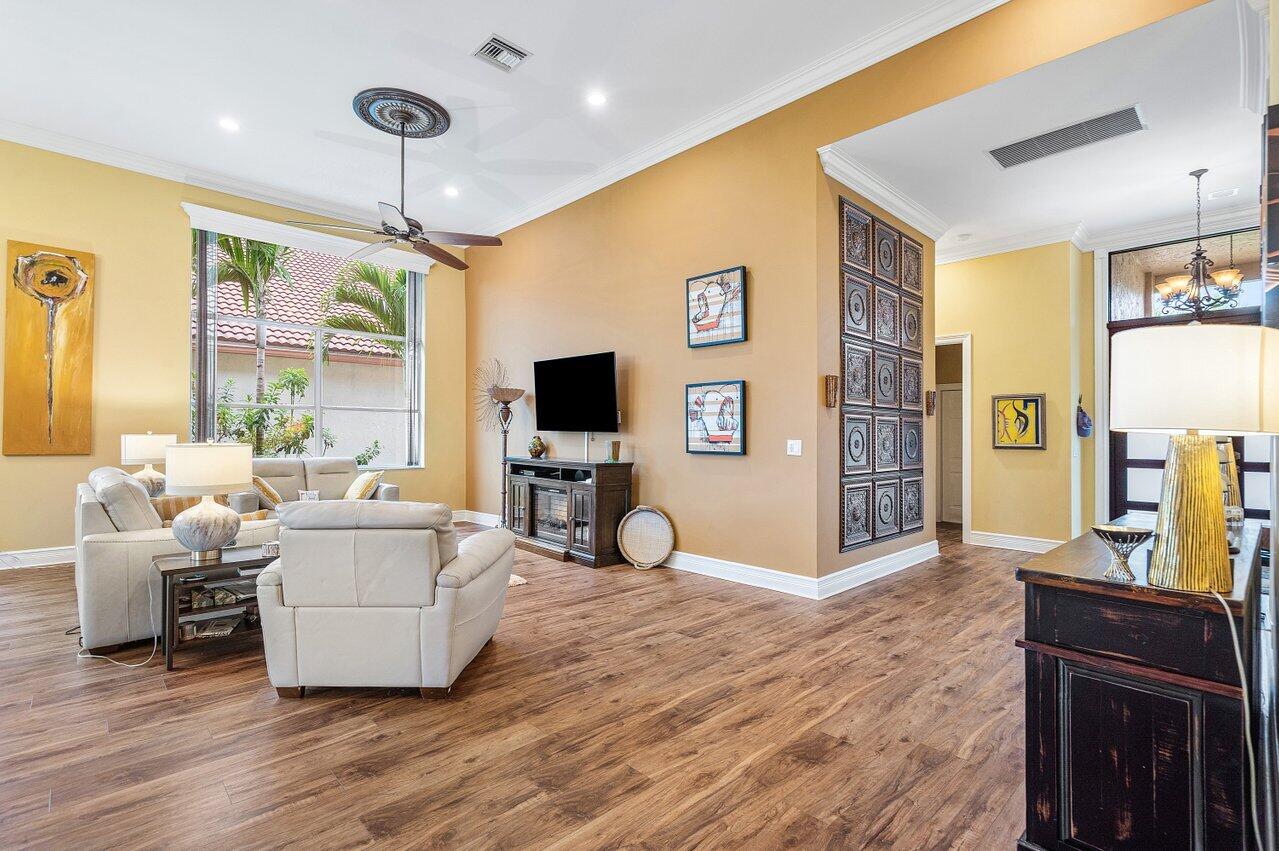 6052 Terra Mere Circle Boynton Beach, FL 33437 - Photo 9 of 52 a living room with furniture a flat screen tv and a dining table