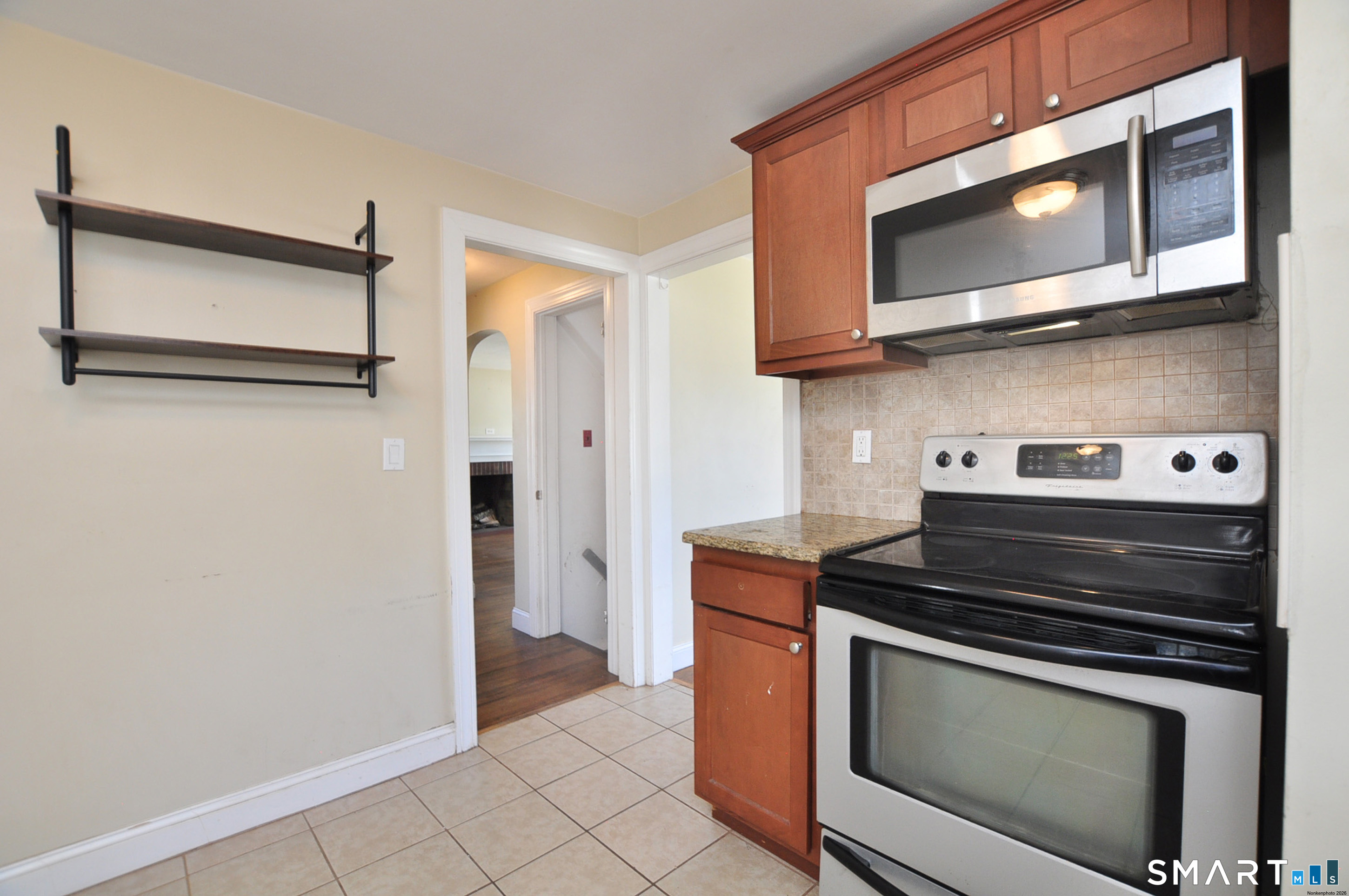 103 West Center Street Manchester, CT 06040 - Photo 15 of 29 a kitchen with stainless steel appliances granite countertop cabinets and a stove top oven