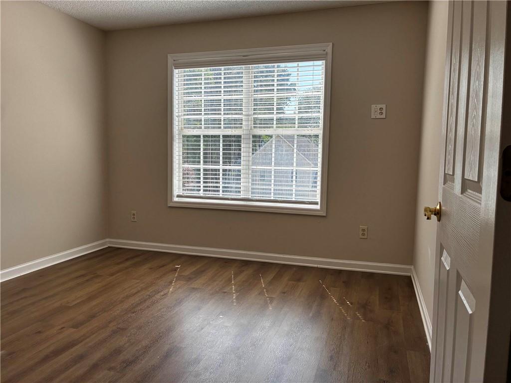 337 Madison Avenue Hampton, GA 30228 - Photo 14 of 32 a view of an empty room with wooden floor and a window