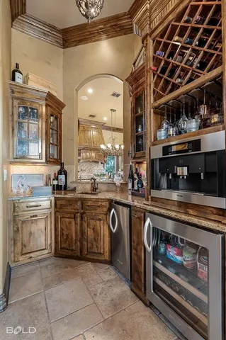 a large kitchen with stainless steel appliances granite countertop a stove and cabinets