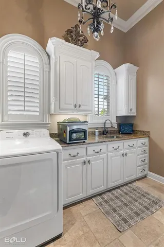 a kitchen with a sink stove and cabinets