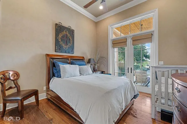 a bedroom with a bed a dresser next to a window