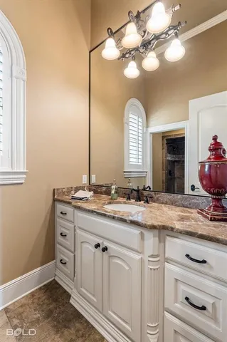 a bathroom with a sink vanity and a mirror