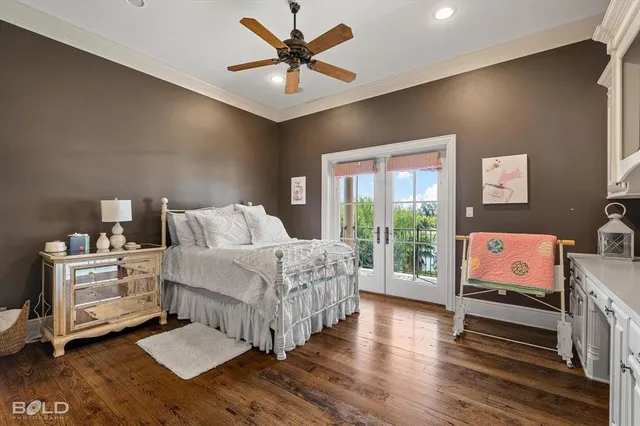 a bedroom with furniture and a large window