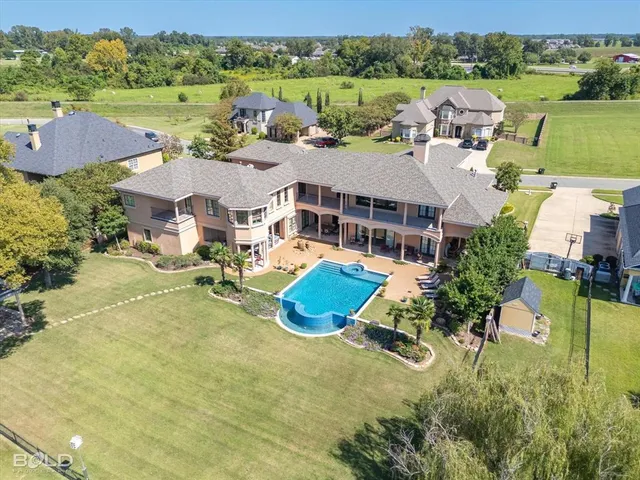 an aerial view of a house with garden space and lake view