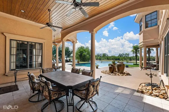 a view of a patio with a dining table and chairs