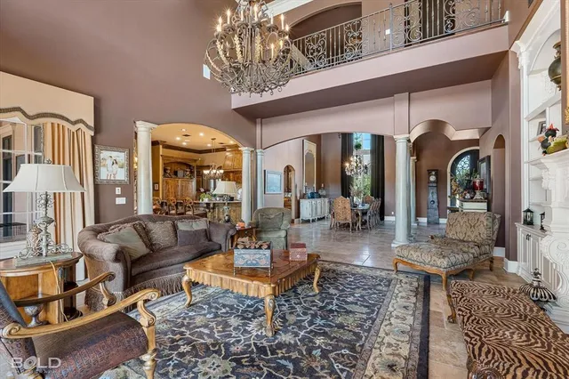 a living room with furniture a chandelier and a chandelier