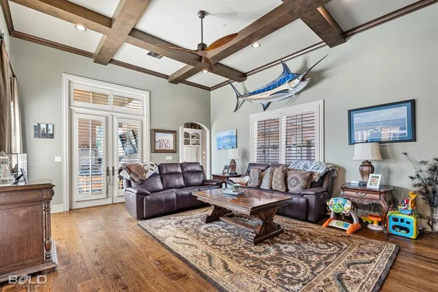 a living room with furniture and wooden floor