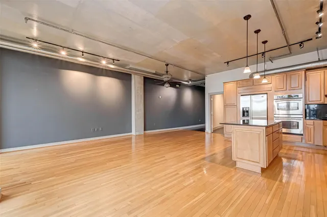 a kitchen with stainless steel appliances a sink and cabinets