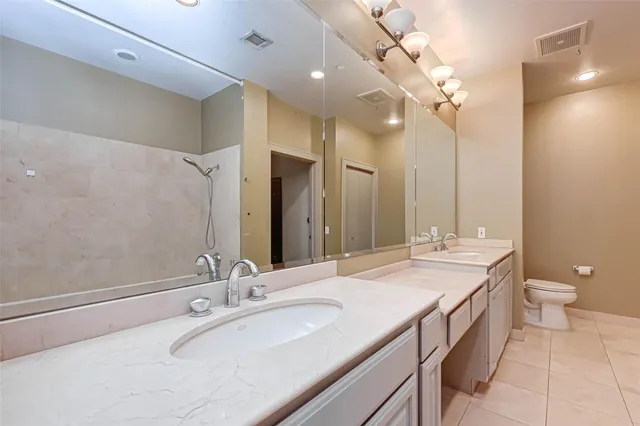 a spacious bathroom with a tub sink shower and mirror