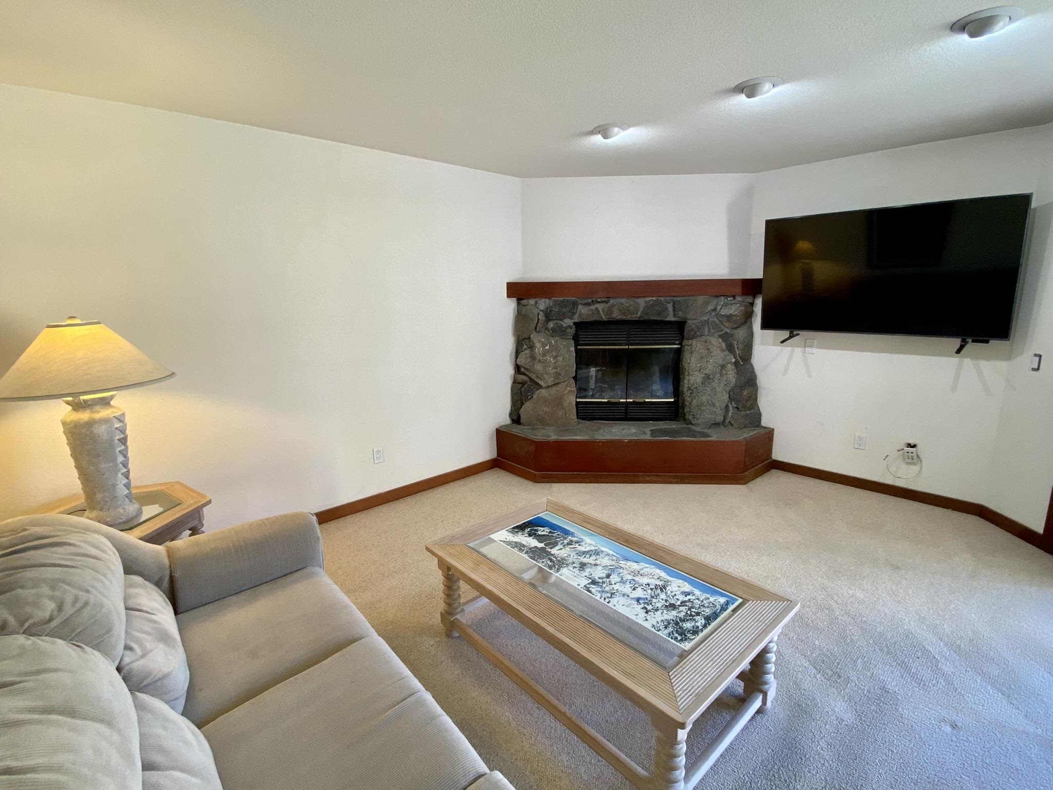 1591 Olympic Vly Road, Unit 28 Olympic Valley, CA 96146 - Photo 4 of 18 a living room with furniture and a flat screen tv