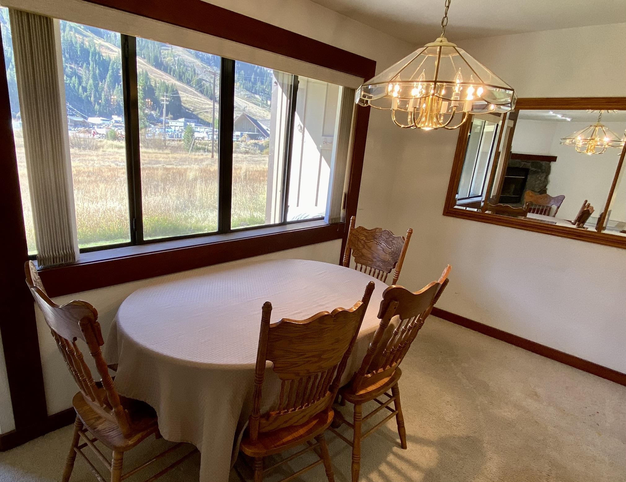 1591 Olympic Vly Road, Unit 28 Olympic Valley, CA 96146 - Photo 8 of 18 a view of a dining room with furniture and chandelier