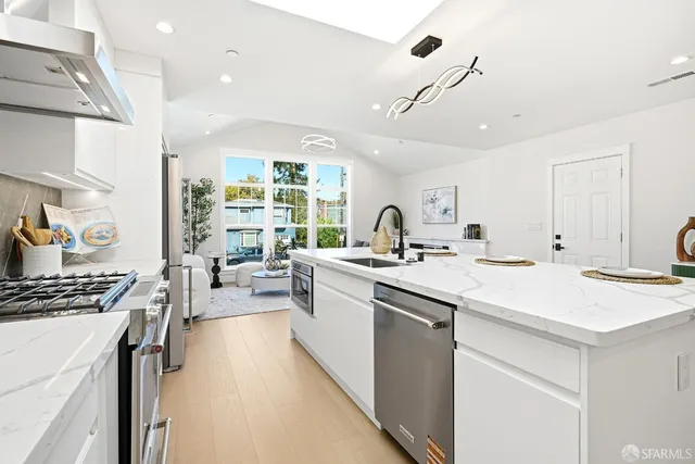 a kitchen with counter top space a sink stove and cabinets
