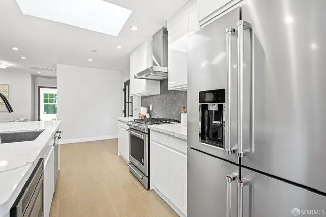 a kitchen with granite countertop a sink and stainless steel appliances