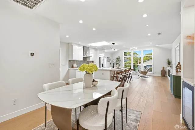 a view of a dining room with furniture and a potted plant