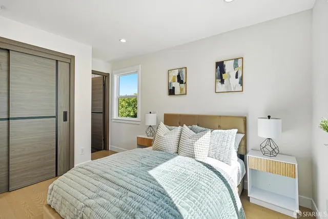 a bedroom with a bed and a window