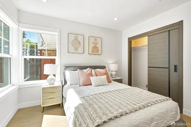 a bedroom with a large bed and a window