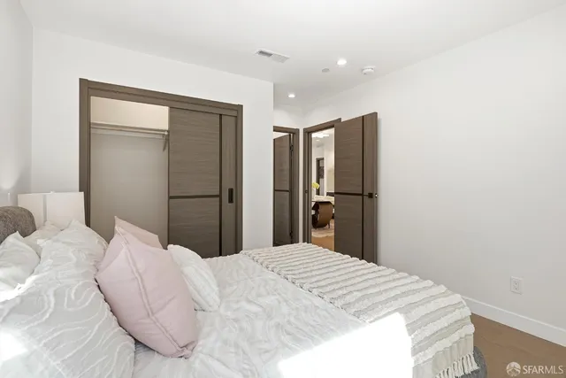 a bedroom with a bed and a mirror