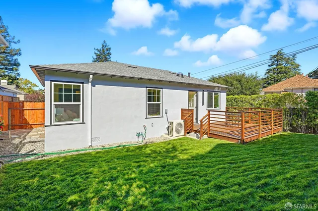 a backyard of a house with table and chairs