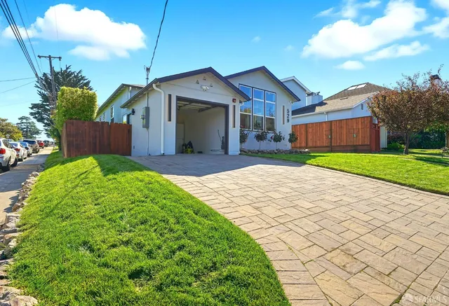 a front view of a house with a yard and pathway