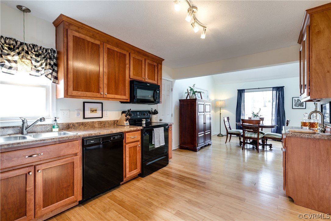 13835 Happy Hill Road Chester, VA 23831 - Photo 15 of 35 a kitchen with stainless steel appliances granite countertop a stove top oven a sink dishwasher a dining table and chairs with wooden floor